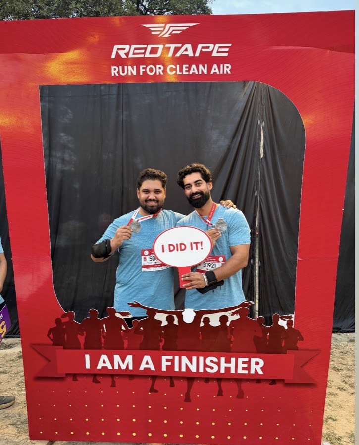 Two runners holding finisher medals at the Run for Clean Air 10K.